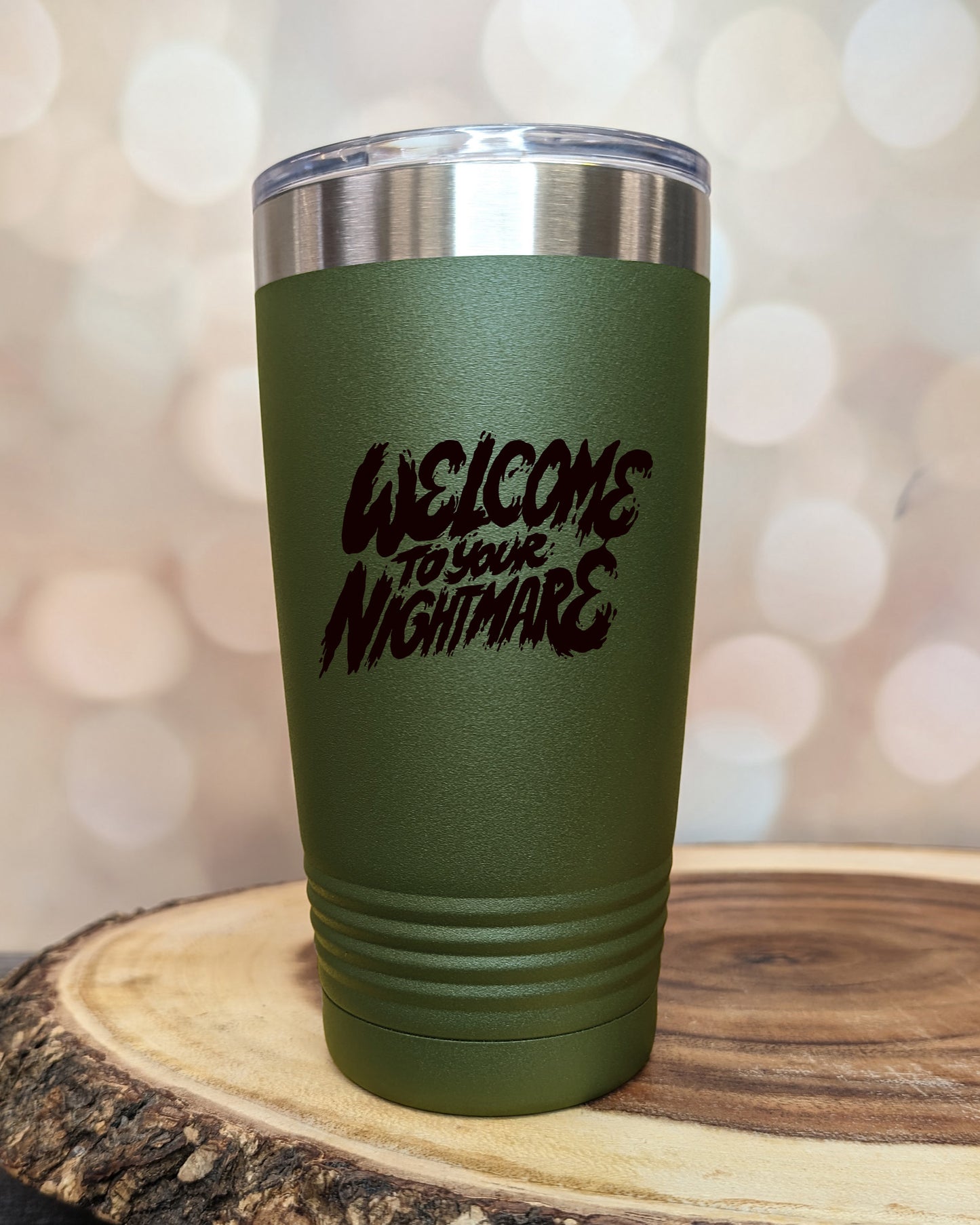 Insulated tumbler featuring Welcome to Your Nightmare horror-themed typography, available in multiple colors and sizes including 20 oz, 30 oz, and 40 oz.