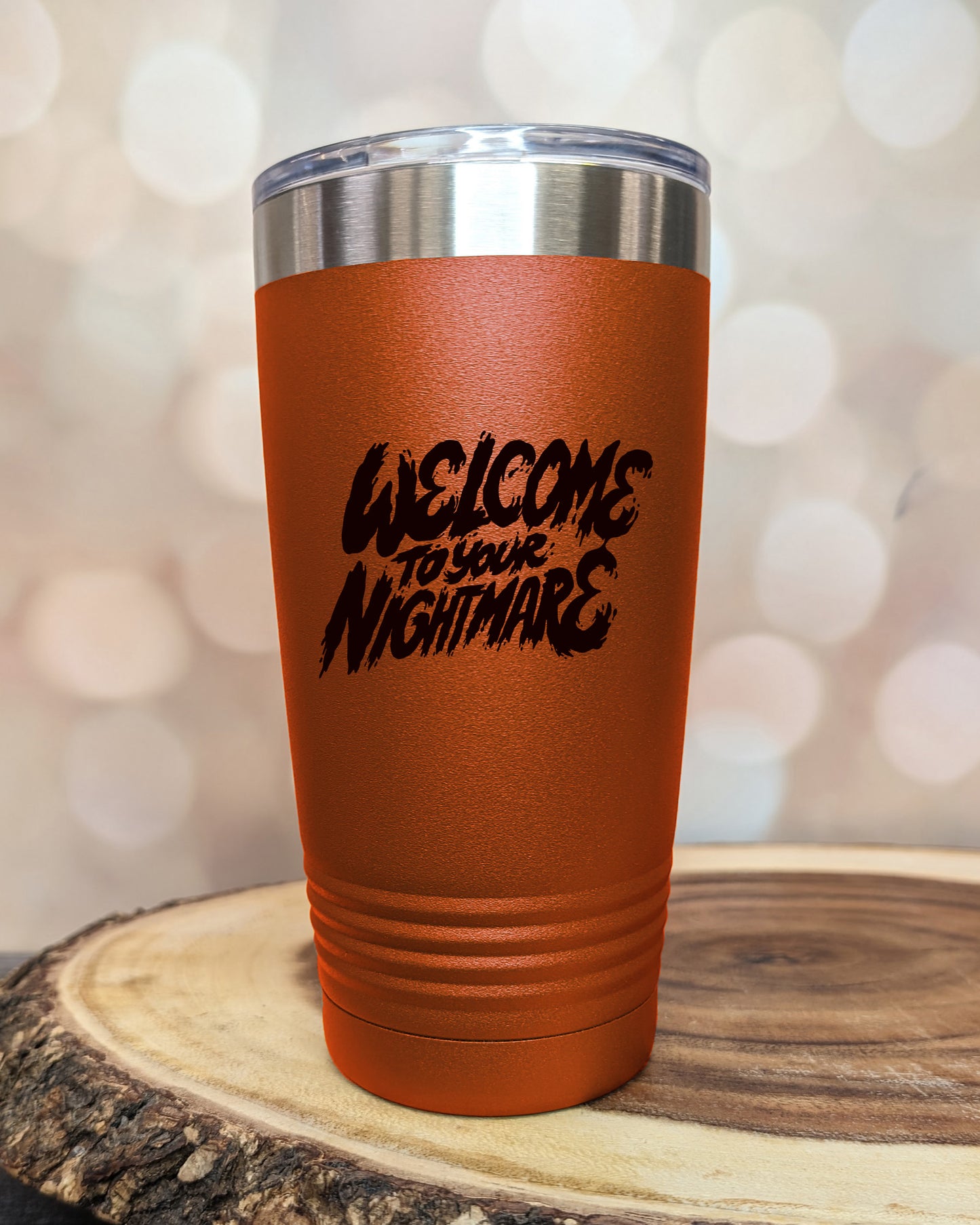 Insulated tumbler featuring Welcome to Your Nightmare horror-themed typography, available in multiple colors and sizes including 20 oz, 30 oz, and 40 oz.