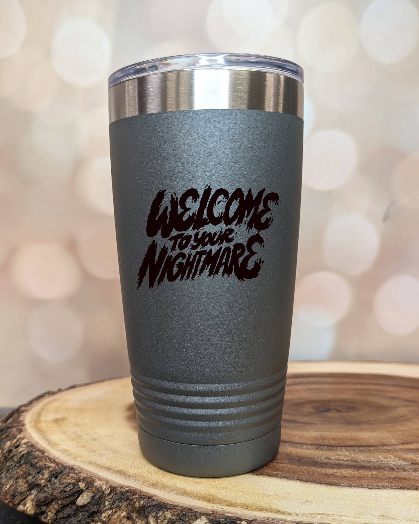 Insulated tumbler featuring Welcome to Your Nightmare horror-themed typography, available in multiple colors and sizes including 20 oz, 30 oz, and 40 oz.