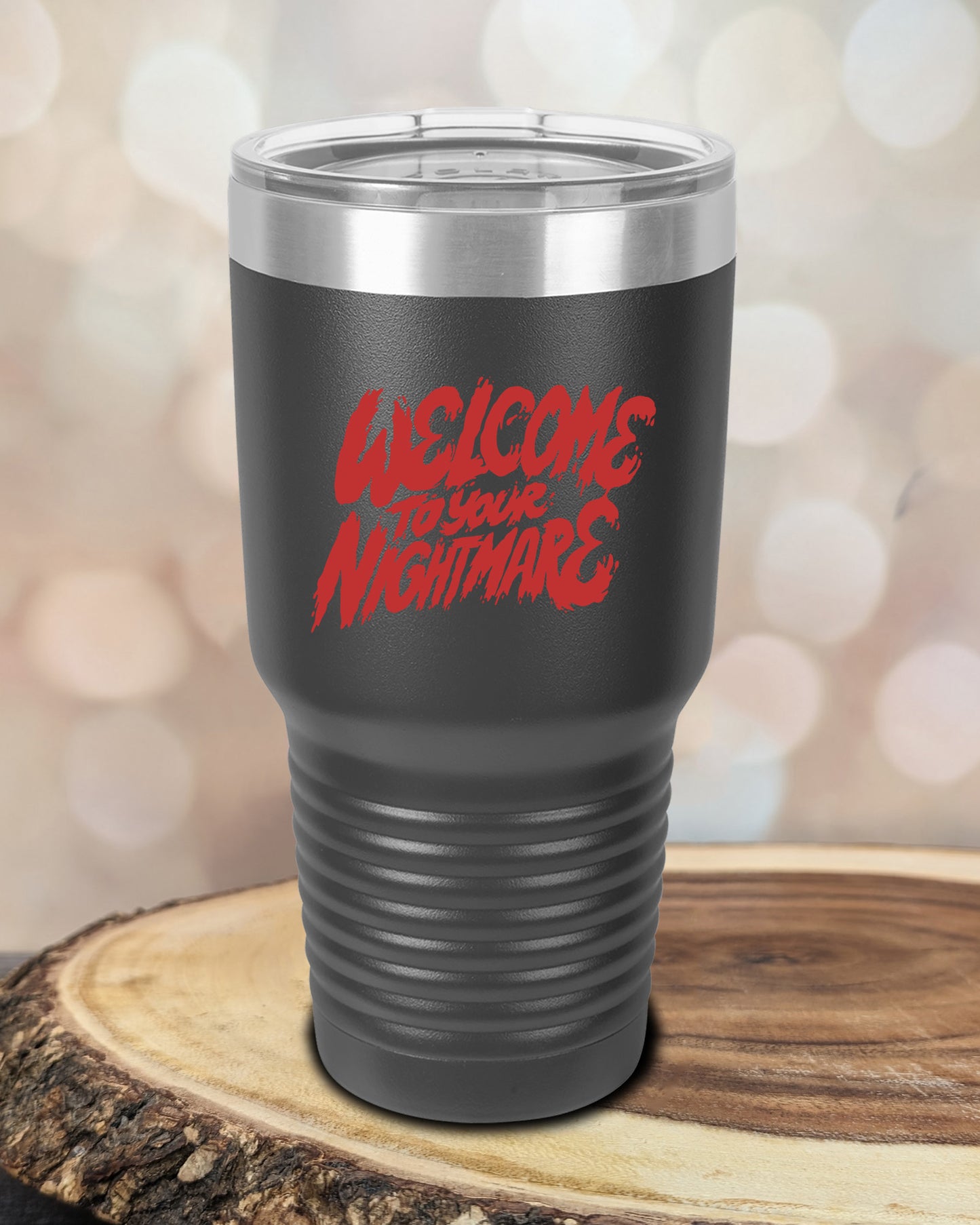 Insulated tumbler featuring Welcome to Your Nightmare horror-themed typography, available in multiple colors and sizes including 20 oz, 30 oz, and 40 oz.