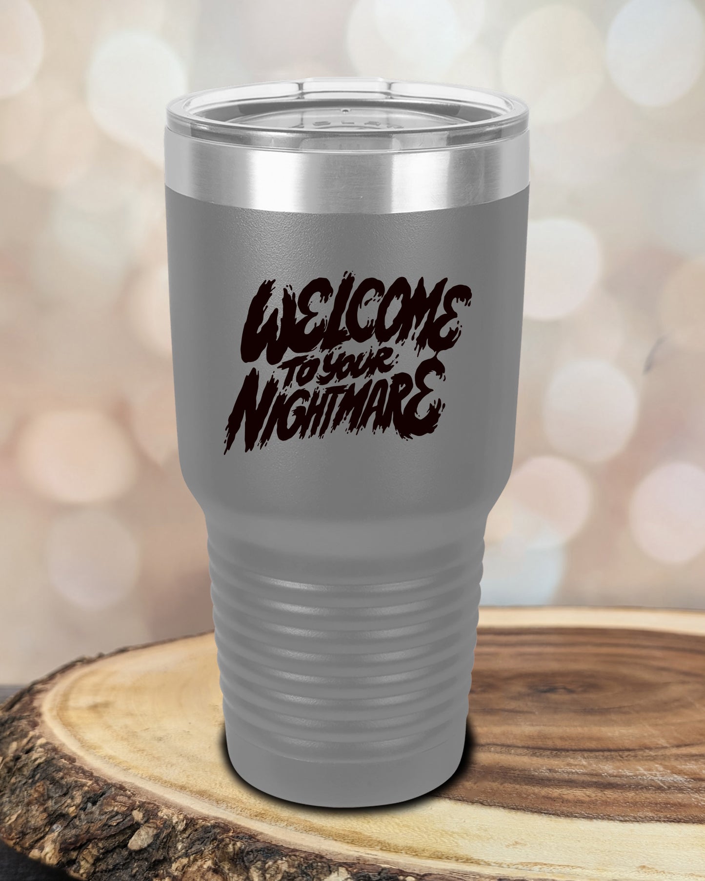 Insulated tumbler featuring Welcome to Your Nightmare horror-themed typography, available in multiple colors and sizes including 20 oz, 30 oz, and 40 oz.