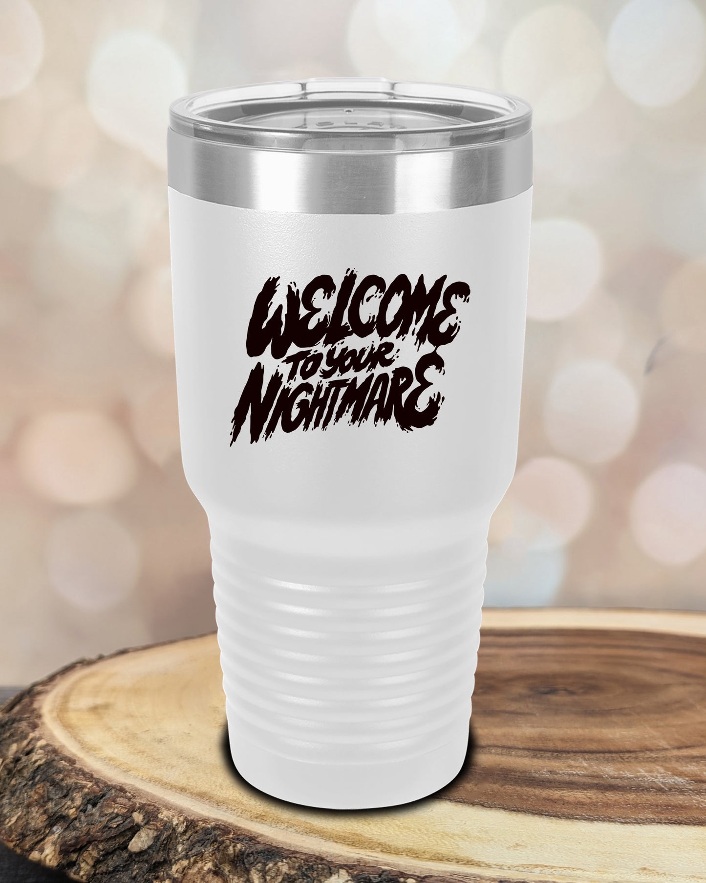 Insulated tumbler featuring Welcome to Your Nightmare horror-themed typography, available in multiple colors and sizes including 20 oz, 30 oz, and 40 oz.